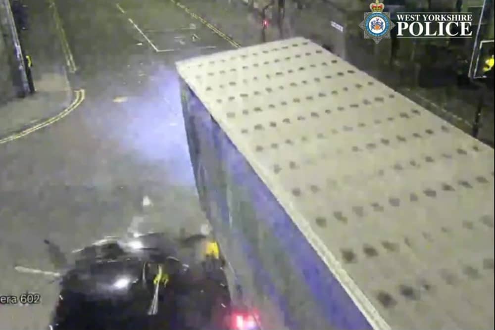 The car is seen smashing into the lorry.
