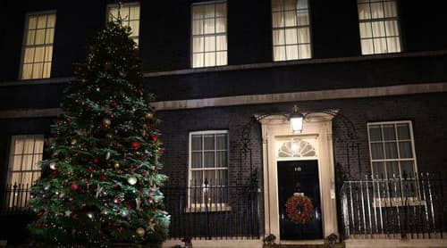 A Christmas tree stands illuminated outside number 10 Downing Street (Getty Images)