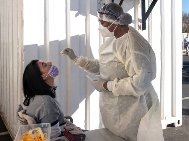 A woman receives a nasal swab, from a health worker wearing personal protective equipment (PPE), to be tested for COVID-19 at the Fourways Life Hospital in Johannesburg (Getty Images)
