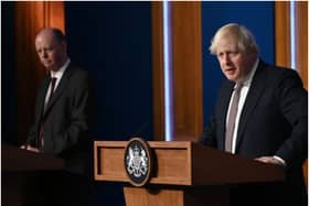 LONDON, ENGLAND - NOVEMBER 15: Prime Minister Boris Johnson standing next to British Chief Medical Officer for England Chris Whitty as he addresses the media regarding the United Kingdom's Covid-19 infection rate and vaccination campaign at Downing Street Briefing Room on November 15, 2021 in London, England. The prime minister and his advisers encouraged Britons to receive their Covid-19 vaccine booster when eligible. (Photo by Leon Neal - WPA Pool/Getty Images)