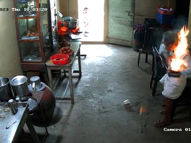 CCTV footage shows the moment a man’s phone bursts into flames in his pocket 