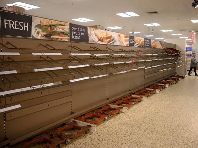 A shopper peruses near-empty bread shelves at a supermarket in the centre of York, northern England, during the first lockdown (Getty Images)