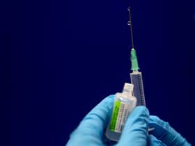 Sodium chloride is measured to be added to a phial of the Pfizer/BioNTech COVID-19 vaccine concentrate ready for administration at Guy’s Hospital in central London