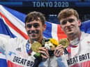 Gold medallists Britain's Thomas Daley (L) and Britain's Matty Lee poses with their medals after wining the men's synchronised 10m platform diving final event during the Tokyo 2020 Olympic Games (Photo by Oli SCARFF / AFP) (Photo by OLI SCARFF/AFP via Getty Images)