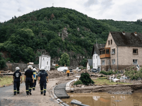 Firefighters inspect debris and damaged houses destroyed by the floods in western Germany (AFP/ Getty)