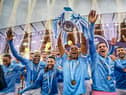Fernandinho of Manchester City lifts the Premier League Trophy with team mates (Photo by Michael Regan/Getty Images)