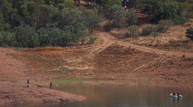 Portuguese firefighterOfficials are seen during a new search operation amid the investigation into the disappearance of Madeleine McCann in the Arade dam, in Silves, near Praia da Luz, on 23 May, 2023.