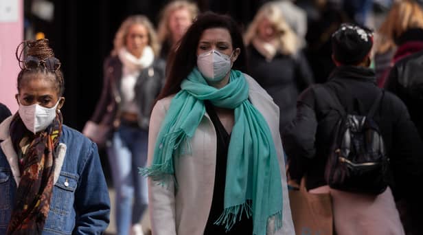 A woman wears a face mask while walking on Oxford Street durng the height of the coronavirus pandemic.