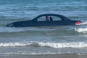 A convertable BMW was washed out to see after parking on a beach in Cornwall