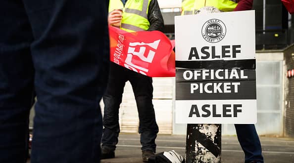 LONDON, ENGLAND - MAY 31: A group of rail workers stand on a picket line outside Euston rail station as a new round of strikes by train drivers begins on May 31, 2023 in London, England. Today's strike comes after the train drivers union, ASLEF, rejected a pay rise offer of 4 percent a year over two years from the Rail Delivery Group (RDG). (Photo by Leon Neal/Getty Images)