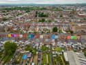 Tasha Frootko and partner Stuart Doust have transformed a street by painting the houses bright colours in Gloucester.