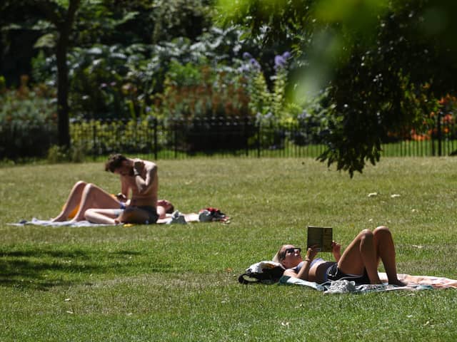 Sunbathers in St James’ Park, London.