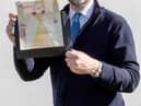 Charles Hanson, owner of Hansons Auctioneers, with a childhood drawing of Queen Elizabeth II drawn by a very young King Charles.  