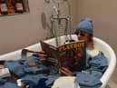 Depop entrepreneur Callum Massey poses in a bath full of deadstock nike beanies from 2002 that he purchased and resold on the site. 