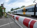 A CCTV clip has shown the heart-stopping moment a woman has a near miss with a train on a level crossing