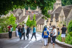 Tourists in Castle Combe, Wiltshire.