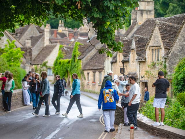 Tourists in Castle Combe, Wiltshire.