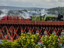 Flying Scotsman passes over the Forth Bridge as part of a series of events to celebrate her centenary. The world famous steam locomotive left Edinburgh before heading north to Aberdeen. 