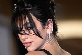 Dua Lipa is set to headline Glastonbury 2024 on Friday night, but will there need to be some “Radical Optimism” regarding the weather for her set on the Pyramid Stage? (Credit: Getty Images)