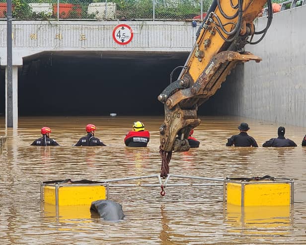 Rescue workers are searching for missing people after a tunnel flooded in South Korea