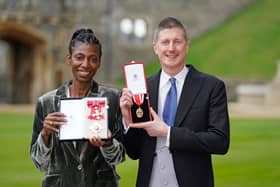 Sharon White poses with her award after she was made a Dame CBE, for public service, next to her husband Sir Robert Chote (Photo by Andrew Matthews - WPA Pool/Getty Images)