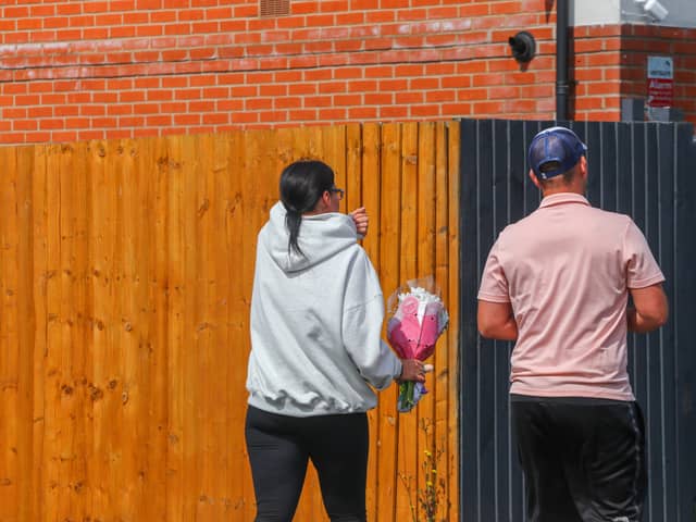 Members of the community lay flowers at the scene of the crash on Turnstone Road, Walsall.
