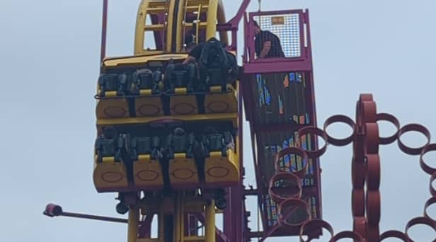 Horrified onlookers watched as rescuers scrambled to the aid of eight terrified people stuck “at the top” of a 22-metre rollercoaster.