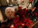  A man lays flowers at a makeshift memorial in honour of Yevgeny Prigozhin.