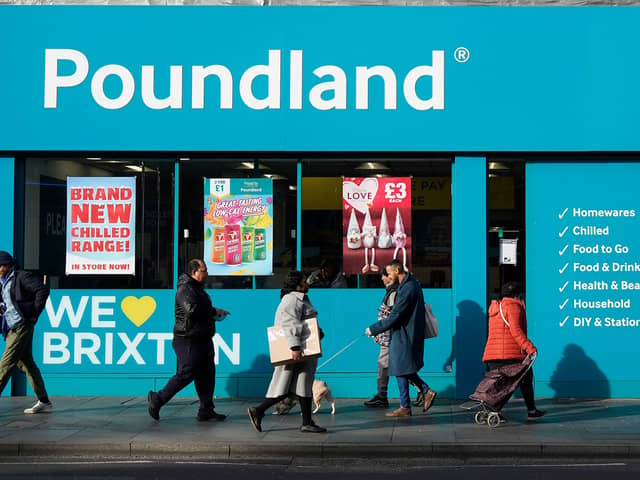 Shoppers walk past a Poundland shop in Brixton, south London.