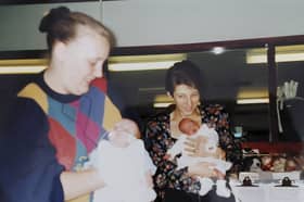 Bronwyn is held by mum Debbie as a baby, and Jack is held by mum Sharon.