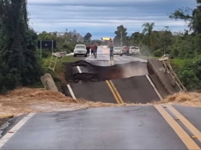 Bridge collapses and plunges into river.