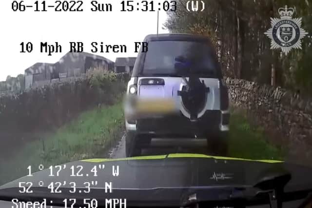 Land Rover driver reverse rams police car.