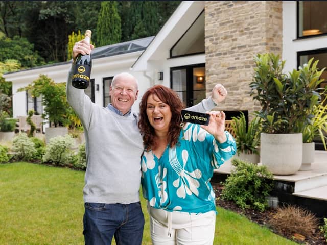Darren & Rachael Reid - Omaze Million Pound House Surrey winners outside their new £3m home 