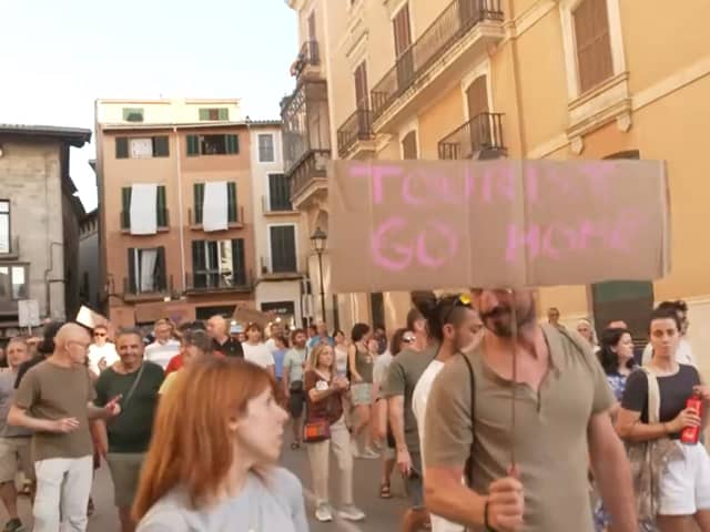 Anti-mass tourism protesters march through Palma’s streets.