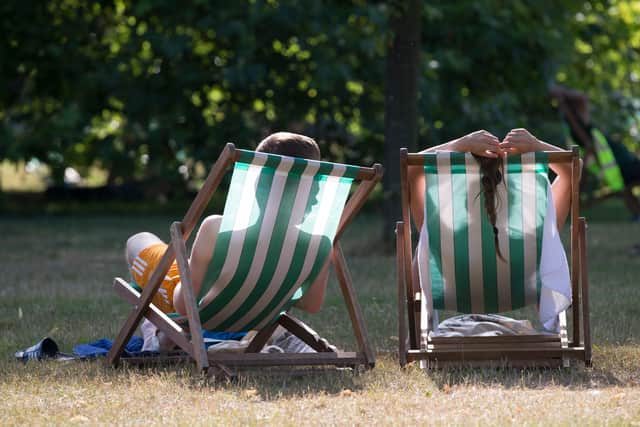 People enjoy warm weather in the park.