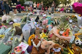 Floral tributes and soft toys are laid following a vigil in Southport, northwest England, on July 30, 2024, a day after a deadly child knife attack. 