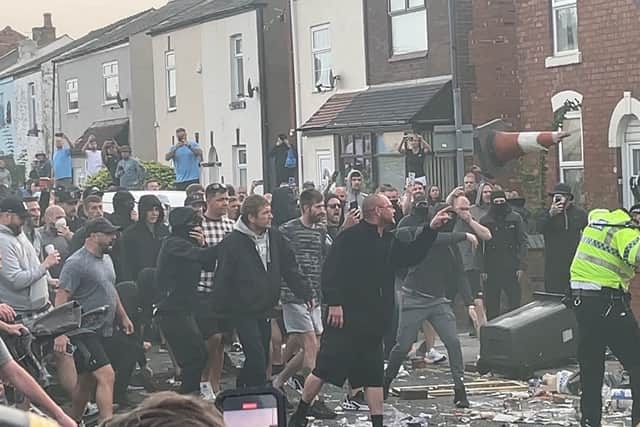 Bottles, bricks and traffic cones were among the items thrown, with police vehicles set alight, a shop looted and officers injured in the chaos. Credit: PA