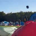 Tent hurtles across sky as Storm Lilian hits Leeds Festival.