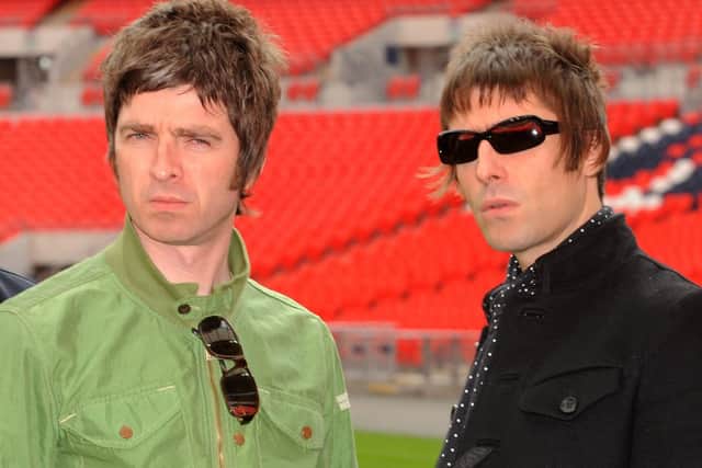 Oasis band members Noel (left) and Liam Gallagher are pictured during a photo call at Wembley Stadium. 