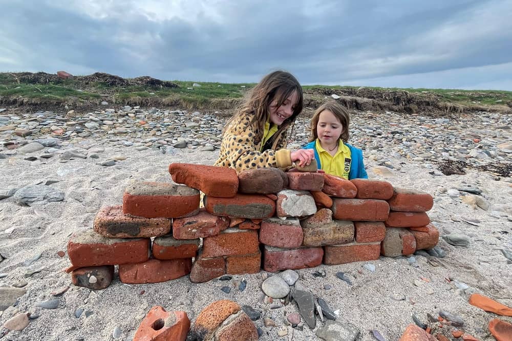 Heidi and Thea on the beach on Holy Island. Meet the family who live on an island that can only be accessed twice a day and only has five children in the local school. 