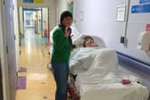Maria Bodea, 86, and daughter Sanda as they wait in hospital corridor after Maria was admitted to hospital after a suspected heart attack.