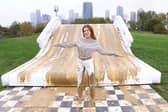 Binky Felstead encourages families to embrace the mud this half term as she's spotted going down a 2.5m high mudslide, created by Bosch at Mudchute Farm. 