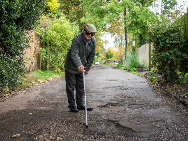 Furious resident Douglas Debnam on Whitebarns Lane in the village of Furneaux Phelham in Hertfordshire, is embroiled in Britain's longest running pothole row.