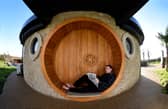 AirB&B host Mike Afflick reads his Lancashire Post while taking a break at his Hobbit House in Inglewhite, near Preston. 