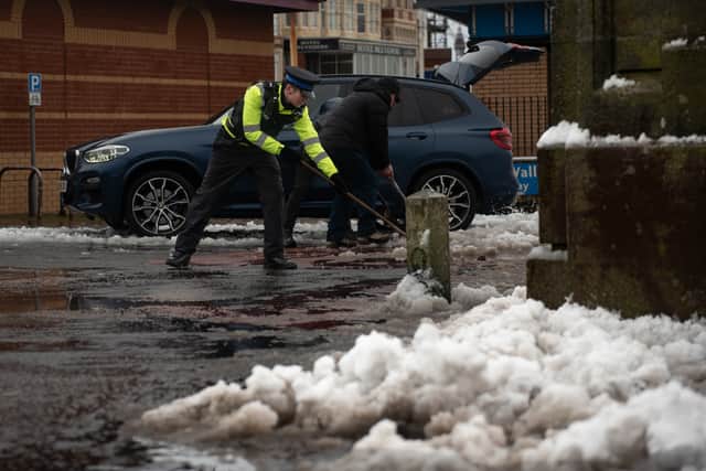 Clearing snow for the Gynn Square memorial service to officers who died in the 1983 rescue mission.|Lucinda Herbert, Blackpool Gazette