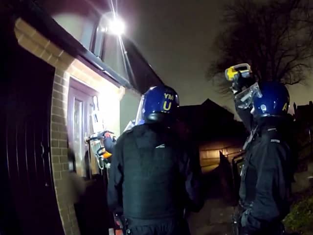 Police used a chainsaw to raid a drug house where they arrested a 13-year-old boy on suspicion of having a zombie knife. 