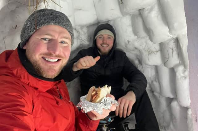 Jordan and Liam builders’ buckets to create snow bricks during the recent cold snap
