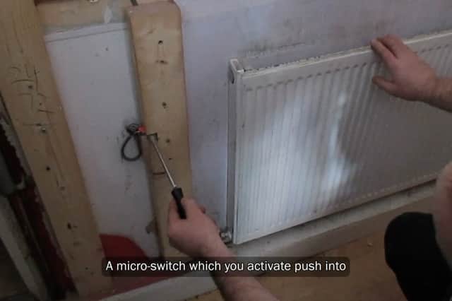 Law enforcement begin to take apart a fake radiator which hid a stash illegal tobacco products.