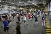 Here are all the details about the Royal Navy's Pre-Joining fitness test, and how you can beat it. Pictured are HMS Queen Elizabeth's ship's company take part in circuits in the hangar.
