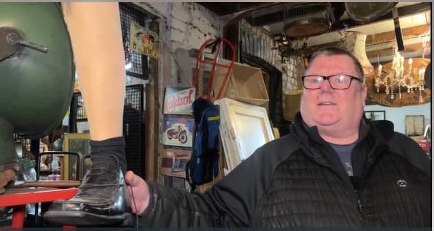 Shop owner holding an artificial leg